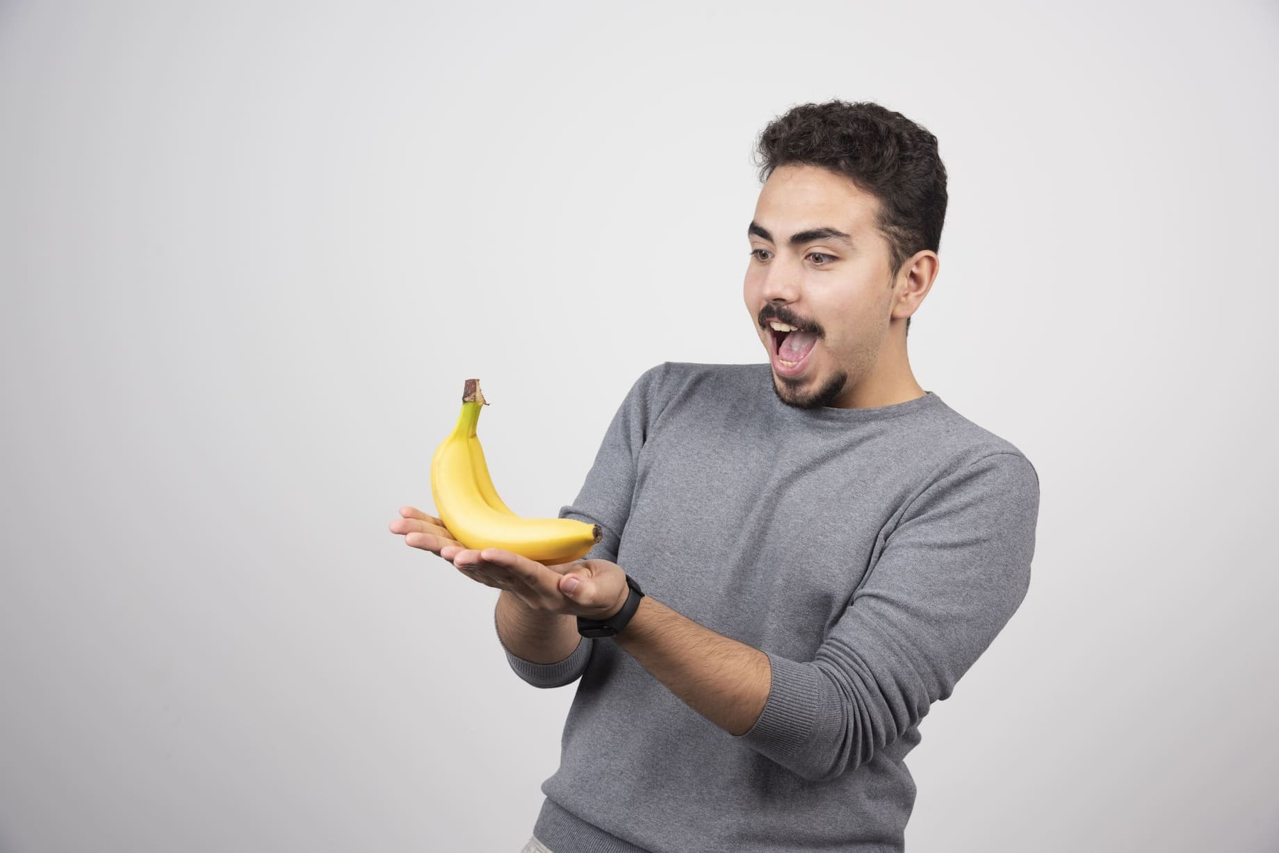 young-man-looking-banana-gray