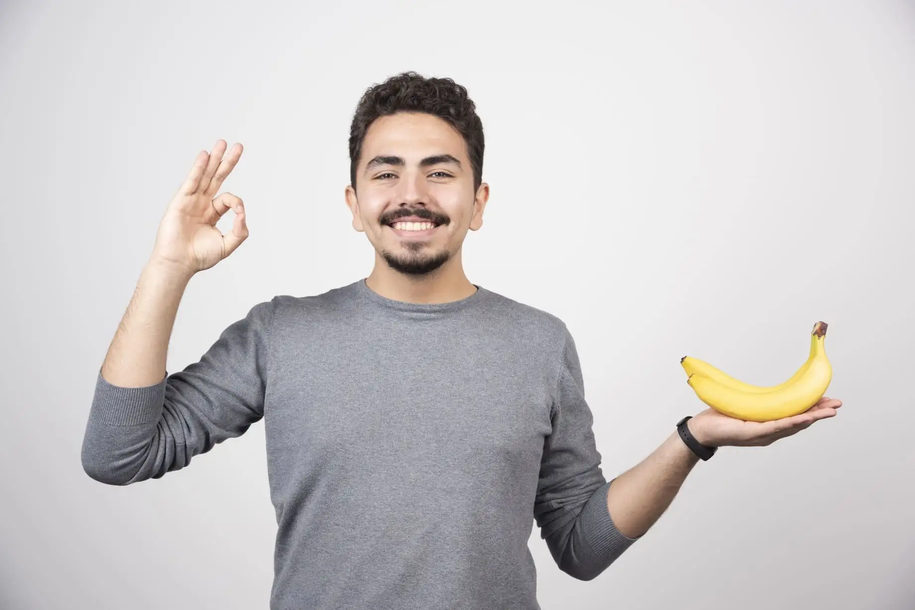 brunette-male-holding-banana-giving-ok-sign-ezgif.com-jpg-to-webp-converter