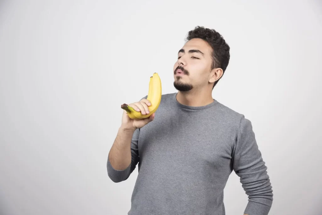 young-man-holding-two-fresh-bananas-ezgif.com-jpg-to-webp-converter